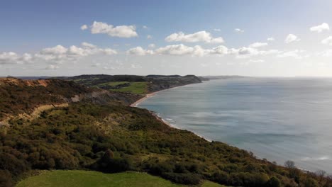 Aerial-shot-of-the-Jurassic-coast-from-Lyme-Regis-looking-towards-Charmouth-on-a-beautiful-summers-day