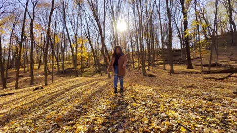 Mädchen-Spielt-Mit-Blättern-Auf-Dem-Boden-Auf-Einem-Wald-Während-Des-Schönen-Reisevideos-Im-Herbst