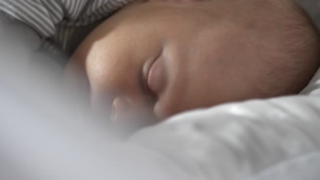 Beautiful-newborn-baby-swinging-in-cradle-and-sleeping,-close-up-shot