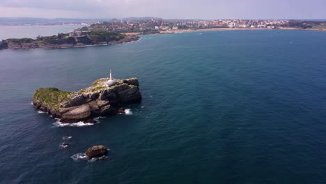 Santander-city-of-north-Spain,-view-of-lighthouse-island-in-the-middle-of-the-ocean-in-the-harbor-port-of-the-town