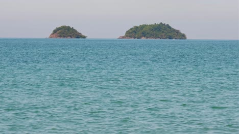 4K-footage,-telephoto-shot-of-two-tropical-islands-with-turquoise-waters-in-the-gulf-of-Thailand