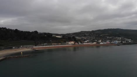 Aerial-panning-left-shot-of-Lyme-Regis-Dorset-England-at-sunrise-on-a-cloudy-day