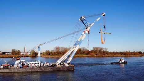 Floating-Crane-And-Tugboat-On-The-River-In-Barendrecht,-Netherlands