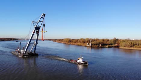 Tugboat-Pulling-The-Floating-Sheerleg-With-A-Large-Crane-At-Inland-Water-Of-Barendrecht-In-Netherlands