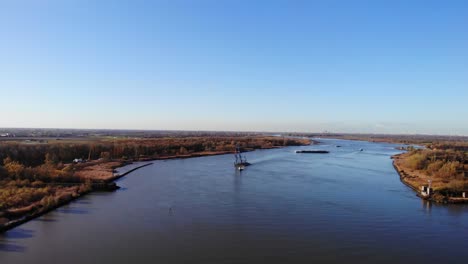 Towboat-Pulling-Floating-Crane-Across-The-River-In-Barendrecht,-Netherlands
