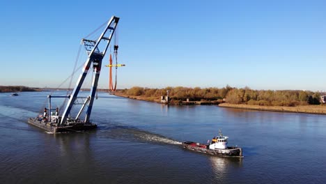 Tugboat-and-Floating-Sheerleg-Sailing-At-The-River-In-Barendrecht,-Netherlands