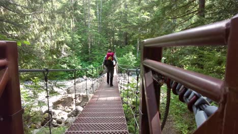 Walking-away-from-camera-on-a-Cable-Bridge-on-Vancouver-Island