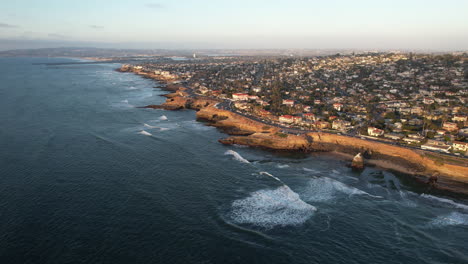 Aerial-view-of-San-Diego-Cliffs,-affluent-suburbia-and-coastline-with-Pacific-Ocean-waves,-California-USA,-high-rise-drone-shot