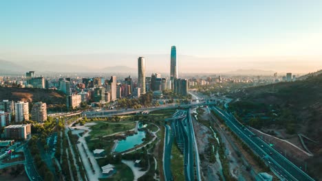 Aerial-hyperlapse-of-the-sunset-over-the-bicentennial-park-of-vitacura-in-santiago-de-chile-with-the-financial-district-in-the-background---drone-shot