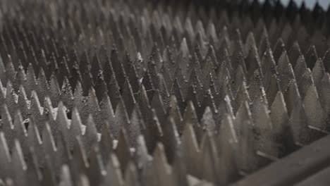 Close-up-of-pointy-tray-with-metal-sheet-moving-into-CNC-machine-for-cutting