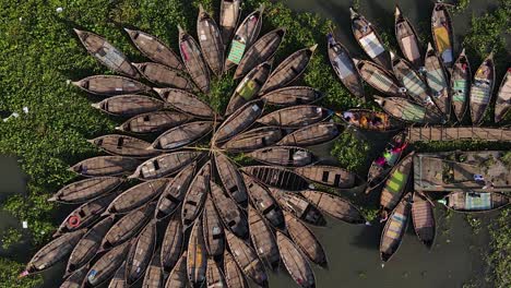 Aerial-Birds-Eye-View-of-Small-Wooden-Boats-Docked-in-a-marsh,-Bangladesh