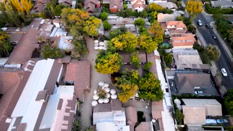 Aerial-view-of-the-town-of-Los-Dominicos-in-Santiago-de-Chile-at-sunset-revealing-the-surrounding-residential-neighborhood---drone-shot
