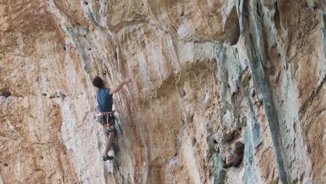 Sport-climber-ascending-on-a-vertical-mountain
