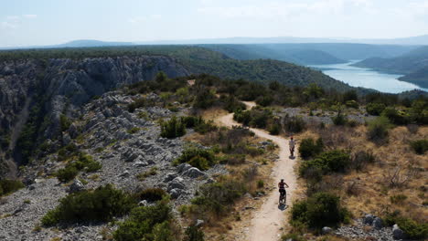 Cyclists-Driving-Towards-The-Viewpoint-In-The-Scenic-Krka-National-Park,-Croatia---aerial-drone-shot