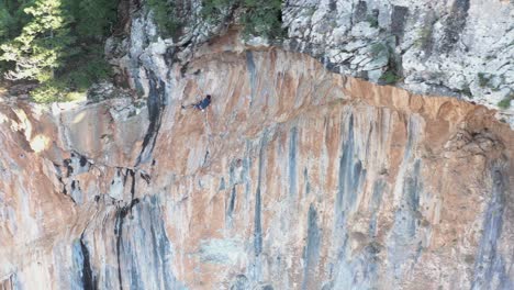 Sport-climber-falls-off-a-vertical-mountain-wall