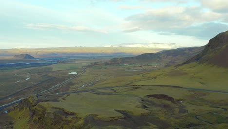 Aerial-high-view-Iceland-Natural-landscape,-green-mountains-horizon,-Ascending-shot