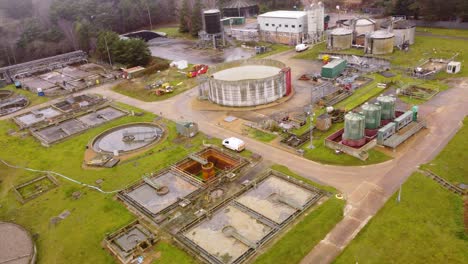 Industrial-wastewater-treatment-plant-factory-in-Thetford,-Norfolk---aerial-drone-shot-:-forest-destruction-concept