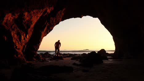 guy-walking-inside-a-Sea-cave-at-El-matador-beach-Malibu-California