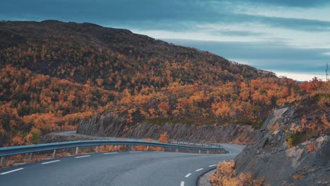 Driving-down-the-curvy-mountain-road-through-the-autumn-valley