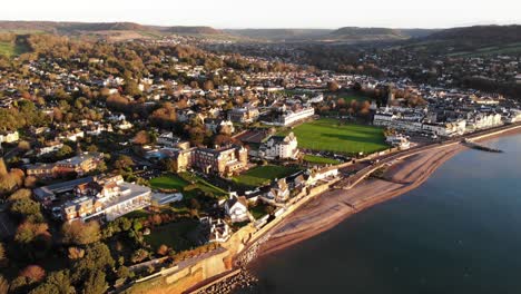 Aerial-View-Of-Sidmouth-Town-Beside-Coastline-Bathed-In-Sunrise-Light