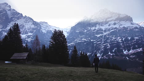 Caucasian-getting-to-see-the-sunrise-in-front-of-huge-mountains,-Switzerland-alps