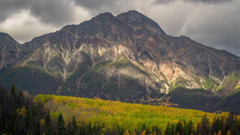 Time-lapse,-idyllic-canadian-landscape,-clouds-and-shadows-moving-above-valley-with-aspen-forest-and-mountain-peak-on-fall-day,-Jasper-National-Park