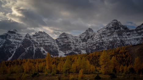 Timelapse,-dramatic-dark-clouds-moving-above-snowy-peaks-and-larch-valley-on-cold-fall-day-in-Banff-National-Park,-Canada
