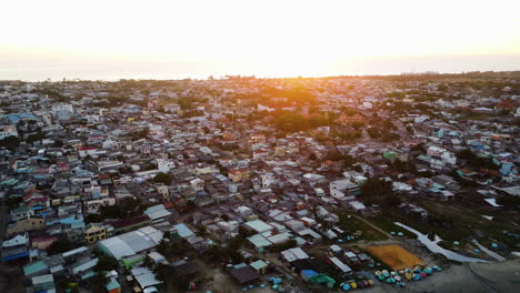 Aerial-flying-backwards-over-Vietnamese-houses-at-early-morning-in-Mui-ne