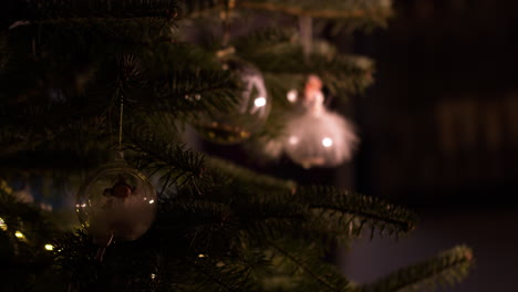 View-of-the-pine-and-ornaments-of-angels-in-glass-balls,-ornaments-for-the-pine-illuminated-by-light-,-static