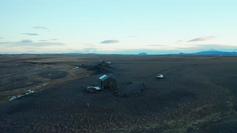 Glass-Cabin-Iceland-glamping-in-black-land-touristic-destination-aerial-shot