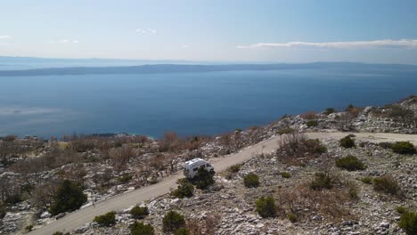 One-camper-van-driving-along-the-Dalmatian-Coast,-on-Sveti-Jure-Road,-Croatia