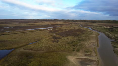 An-aerial-view-of-the-mudflats-and-heather-fields-on-Texel-Island,-Netherlands