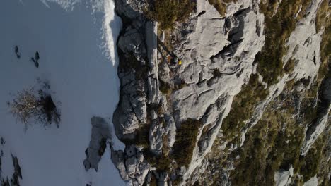 Man-walking-on-top-of-cliff,-Park-prirode-Biokovo-snowy-mountains