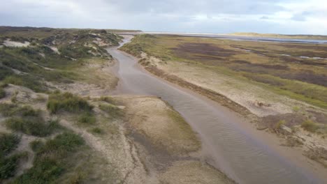 Drone-fly-above-river-in-texel-wadden-sea-island-mudflats,the-netherlands