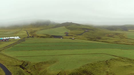 Lowlands-landscape-aerial-view,-green-moss-lands-on-foggy-rainy-weather,-Iceland