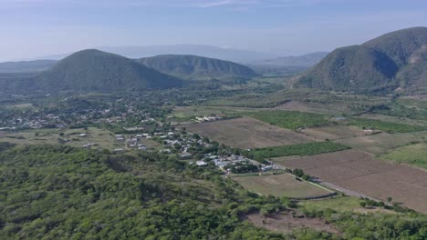 Aerial-forward-descending-over-rural-village-of-Las-Yayas,-Azua-in-Dominican-Republic