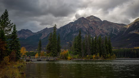 Time-Lapse,-Pyramid-Island-and-Bridge-Over-Pyramid-Lake,-Dramatic-Dark-Clouds-Moving-Above-Peaks-of-Jasper-National-Park,-Canada
