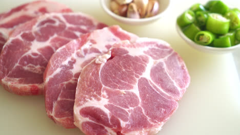 fresh-pork-neck-raw-or-collar-pork-on-board-with-ingredients-for-marinated