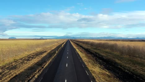 Aerial-Flyover-Empty-Scenic-Icelandic-road-towards-Glacier-Landscape