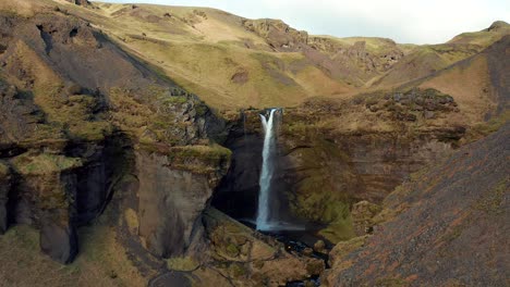 Mountainous-cascade-in-the-middle-of-a-rocky-landscape,-attraction-in-Iceland