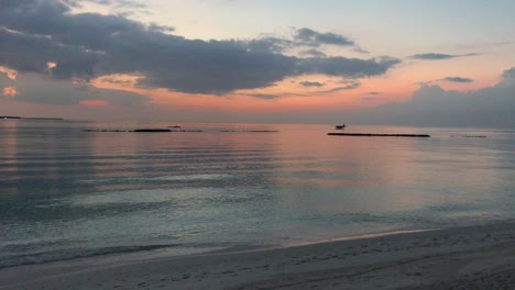 Amazing-orange-dusk-seascape,-relaxing-and-calm-background-horizon-during-sunset,-quiet-beach