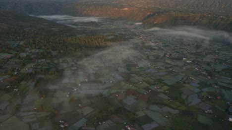 Aerial-view-of-whole-Batur-Caldera-during-sunrise-in-Bali-with-fog