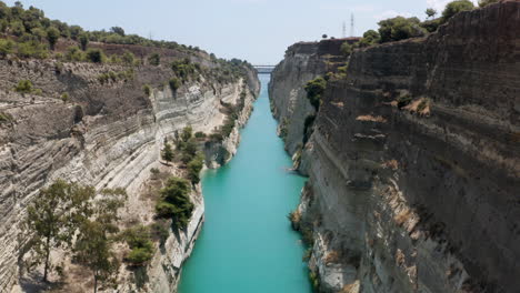 Turquoise-Blue-Water-Of-Corinth-Canal-With-Steep-Cliffs-On-A-Sunny-Day-In-Greece