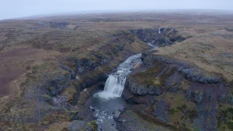 Aerial-orbit-shot-showing-Cascade-Waterfall-falling-into-Sela-River-during-clouds-at-sky-on-Scandinavian