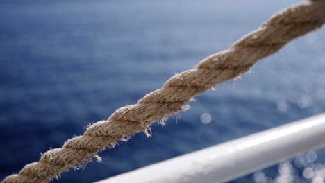 Gimbal-shot-of-ocean-vibes-in-ferry-way-to-Malta,-rope-in-foreground