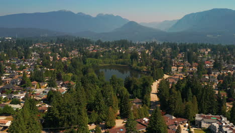Scenic-aerial-view-flying-toward-Como-Lake-Park-in-picturesque-Coquitlam,-Greater-Vancouver