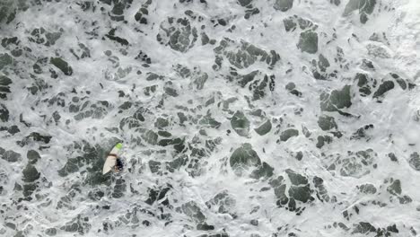 AERIAL---Surfer-gets-sucked-into-ocean-with-the-tide