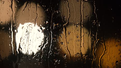 Various-shots-and-camera-movement-of-detailed-rain-drops-falling-on-window