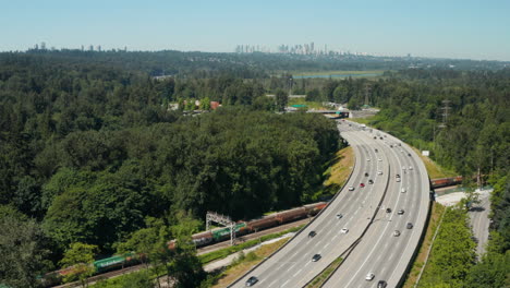Aerial-view-over-the-Trans-Canada-Highway-through-Burnaby-with-the-downtown-Vancouver-skyline-in-the-distance