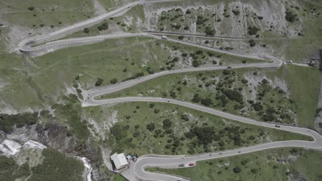 Descriptive-reverse-plane-drone-video-on-ascent-of-the-stelvio-pass-with-peak-to-the-horizon